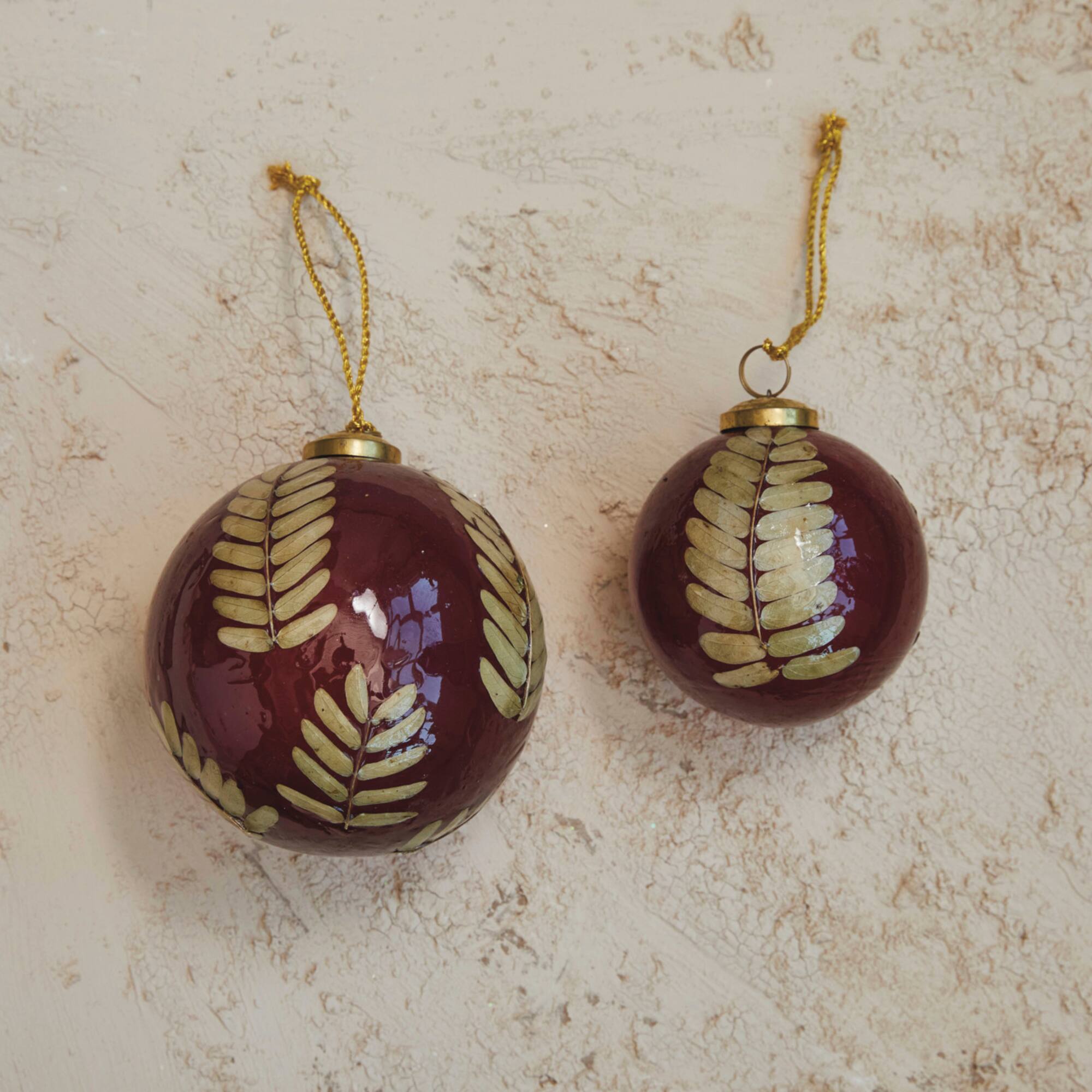 Hello Honey® 4" Red & Gold Embedded Eucalyptus Leaf Ball Glass Ornament